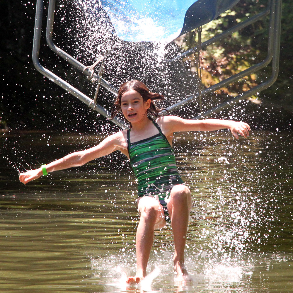 Girl splashes down off camp waterslide