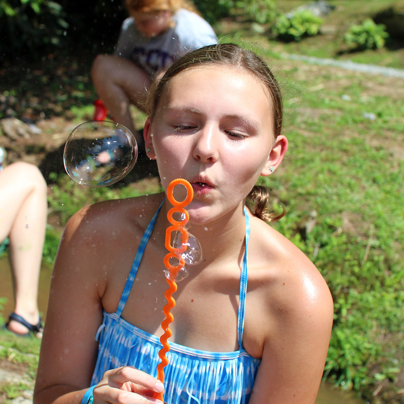 camp girls blowing bubble