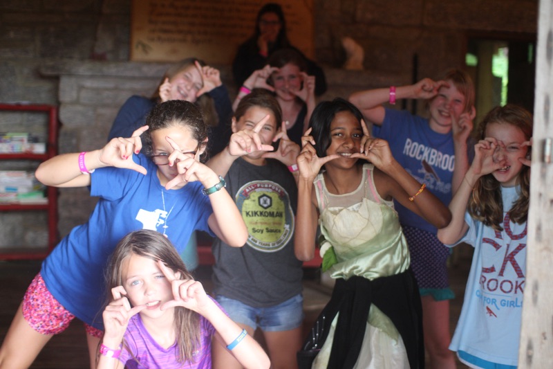 girls making camera sign