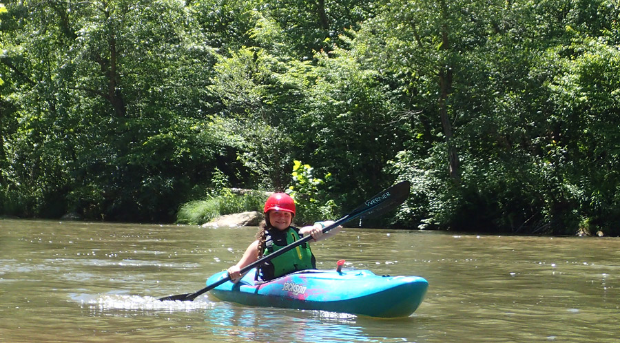 Girl Kayaking down river