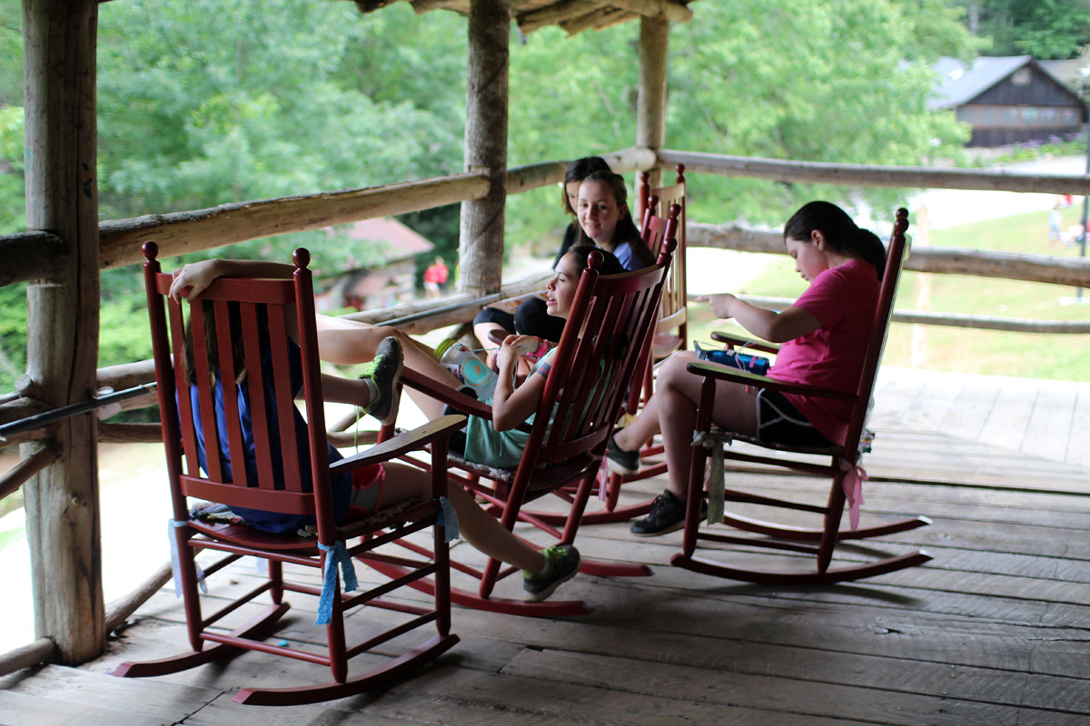 Camp girls talking on porch