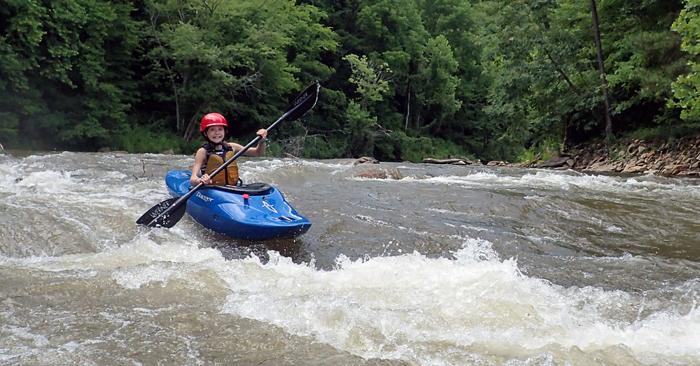 young girl kayaking