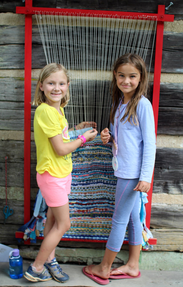 camp girls weaving outside