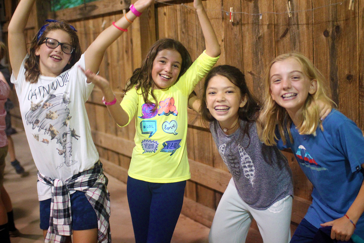 Pre-teen girls at summer camp dance