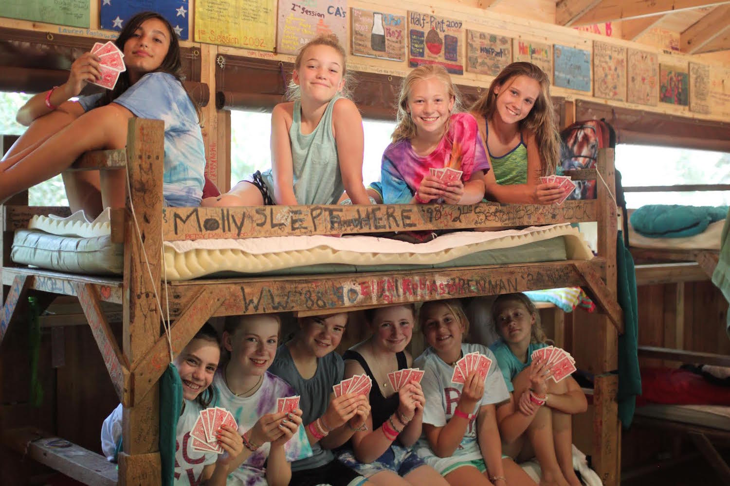 Camp girls inside cabin on bunk bed