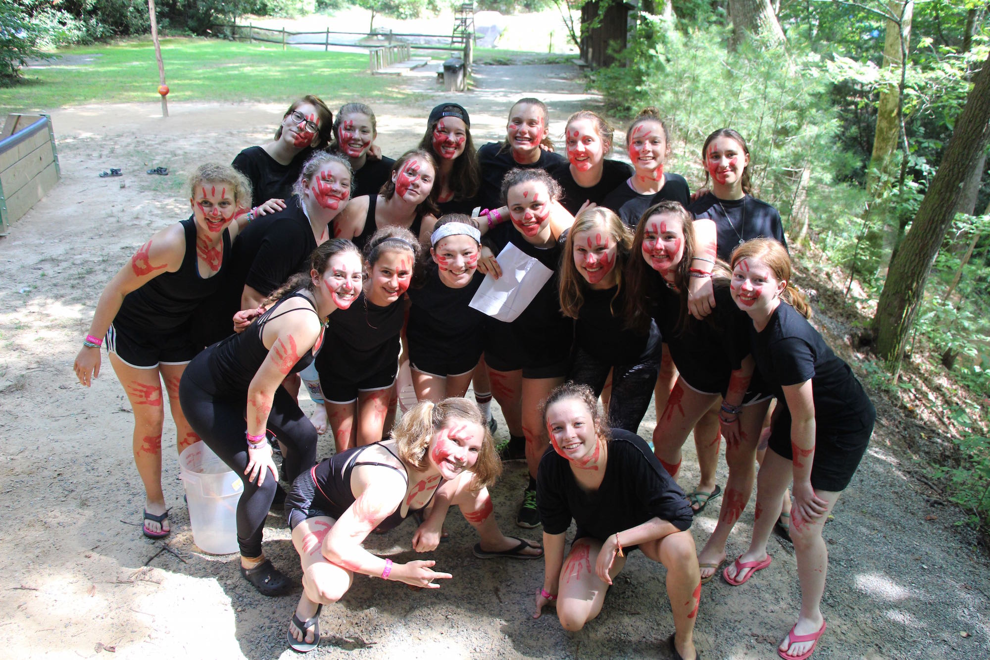 Girls in black with red face hand print