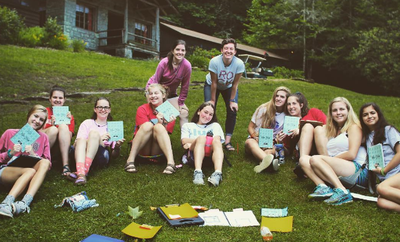 camp friends sitting in camp chairs