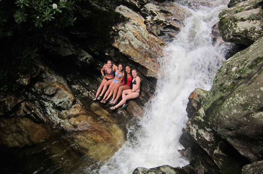 Camp counselors in waterfall