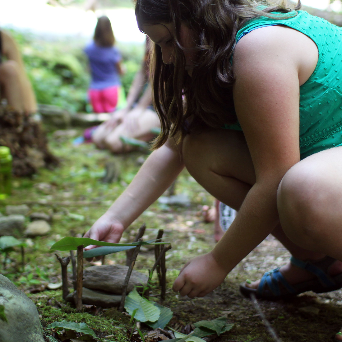 girl building fairy house