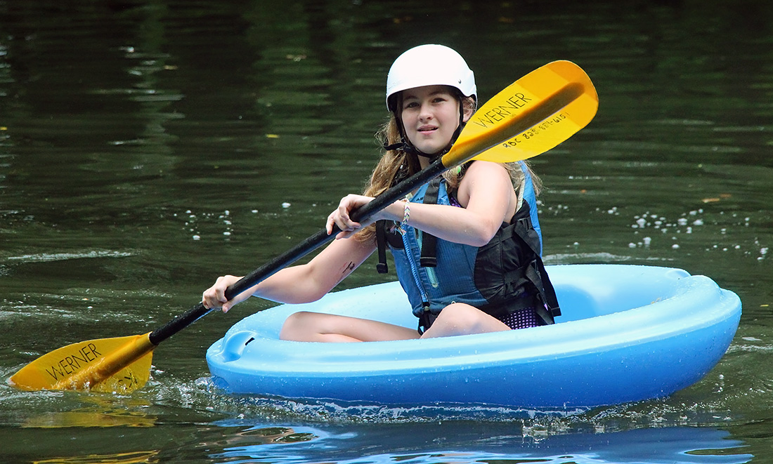 girl paddling coracle corcl