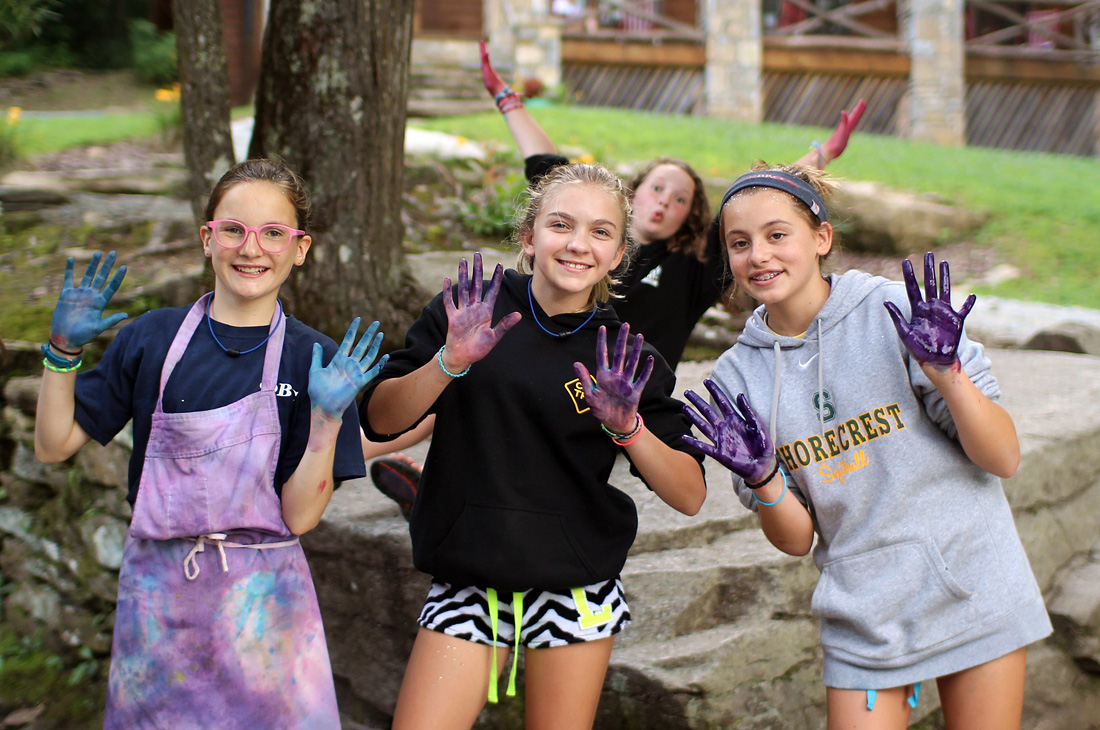 dyed hands from girls tie dyeing t-shirts
