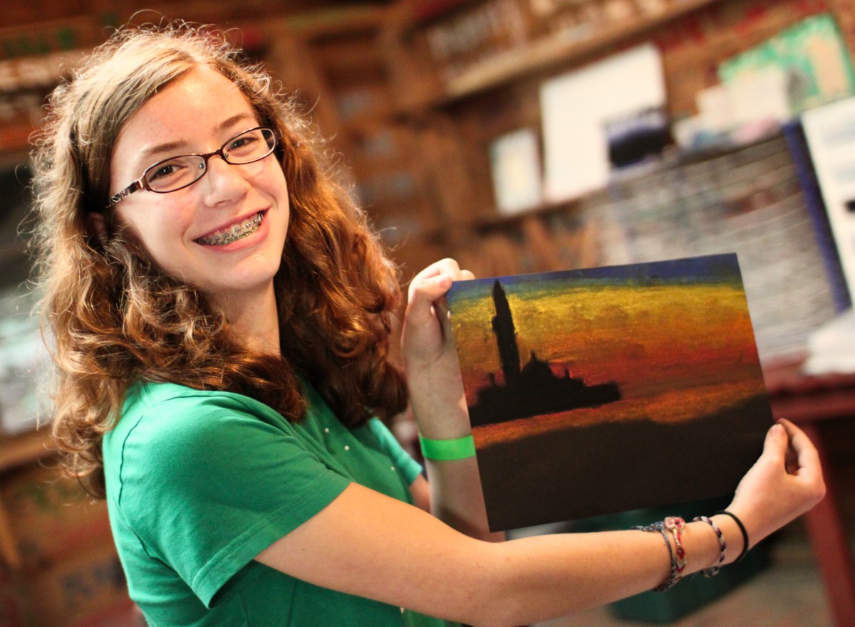 Girl showing her drawing