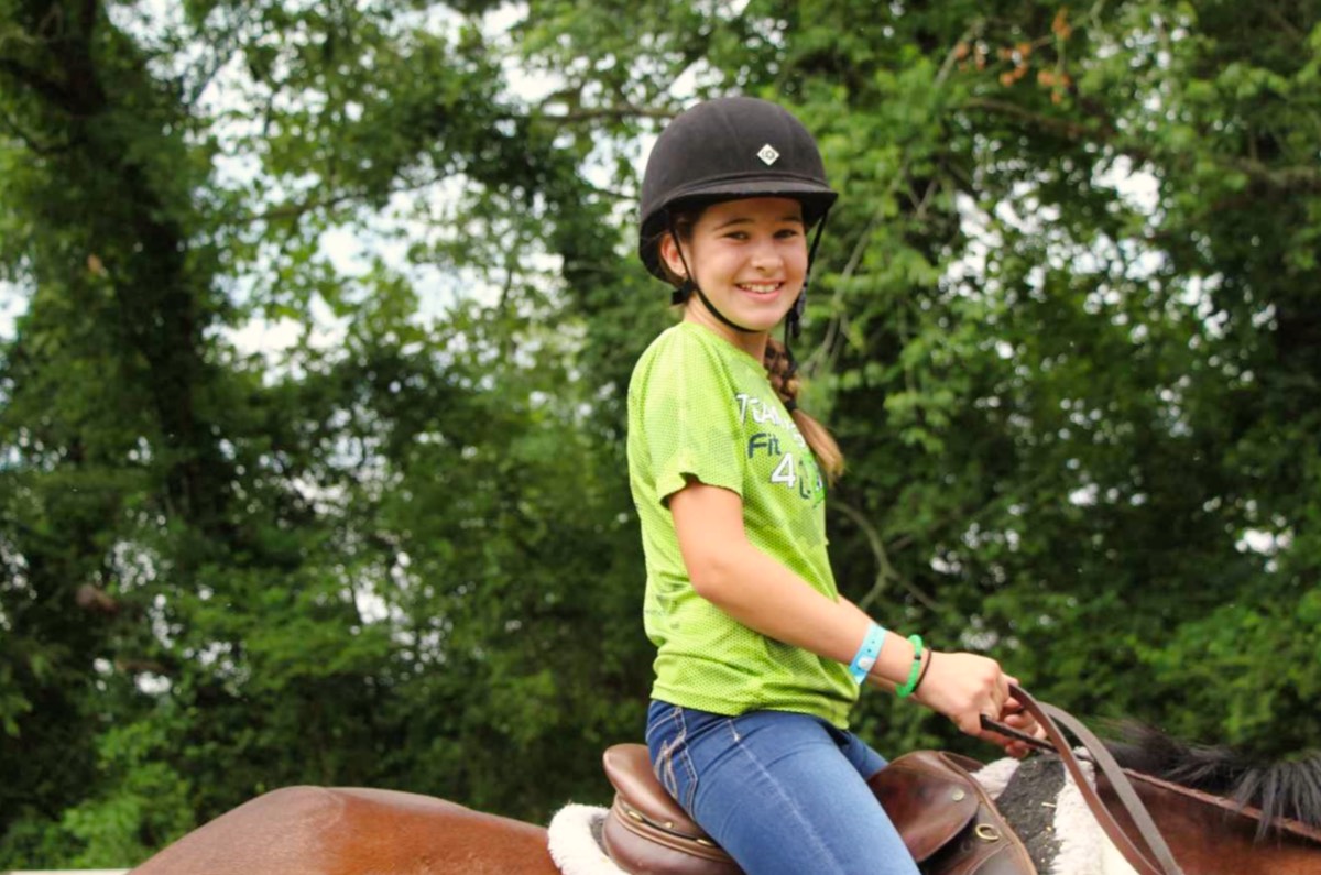 camp girl riding a horse