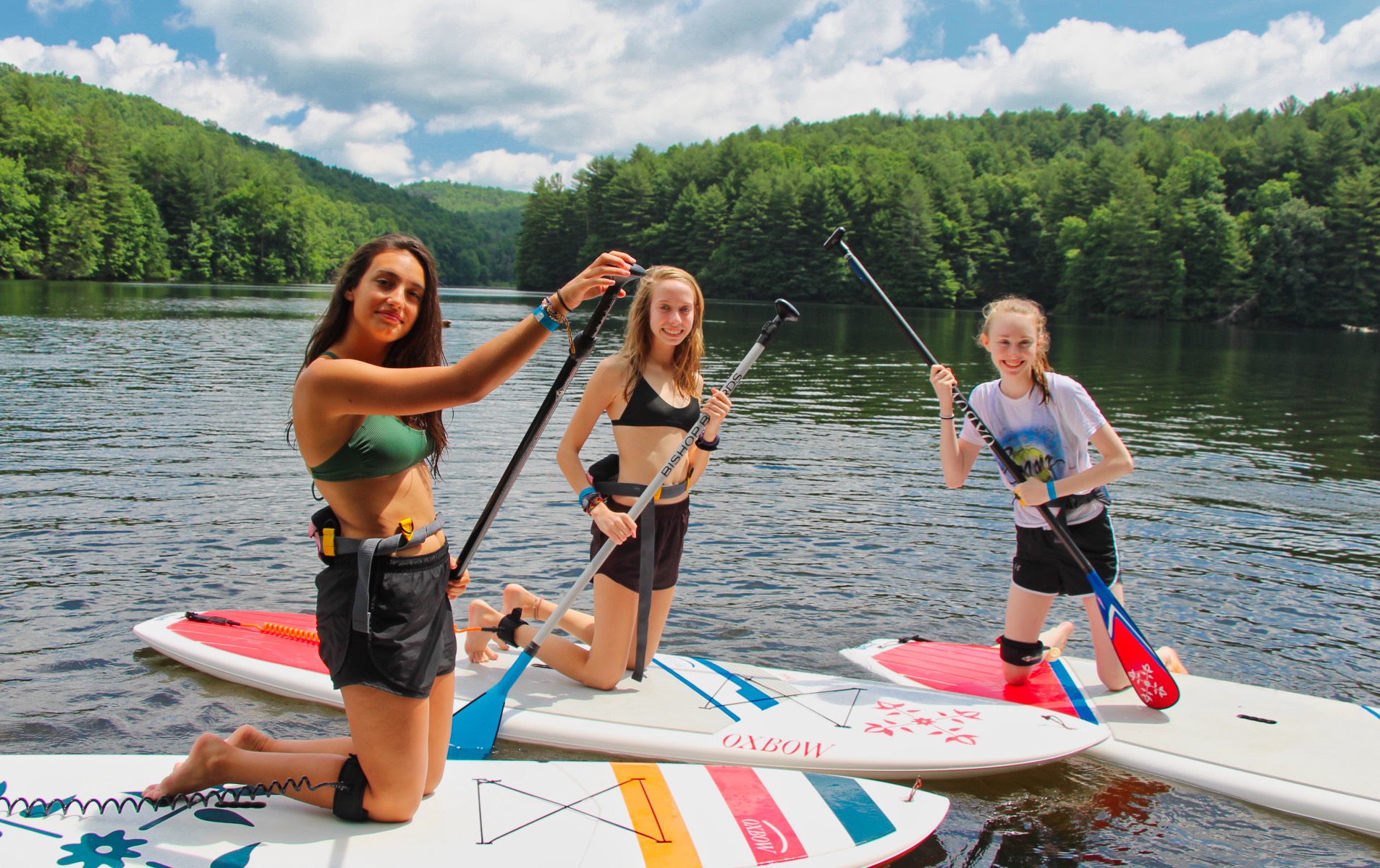 Camp girls paddle boarding