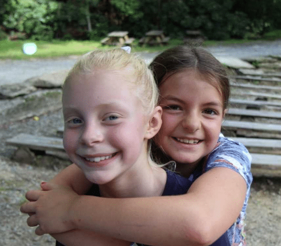 camp friends hugging