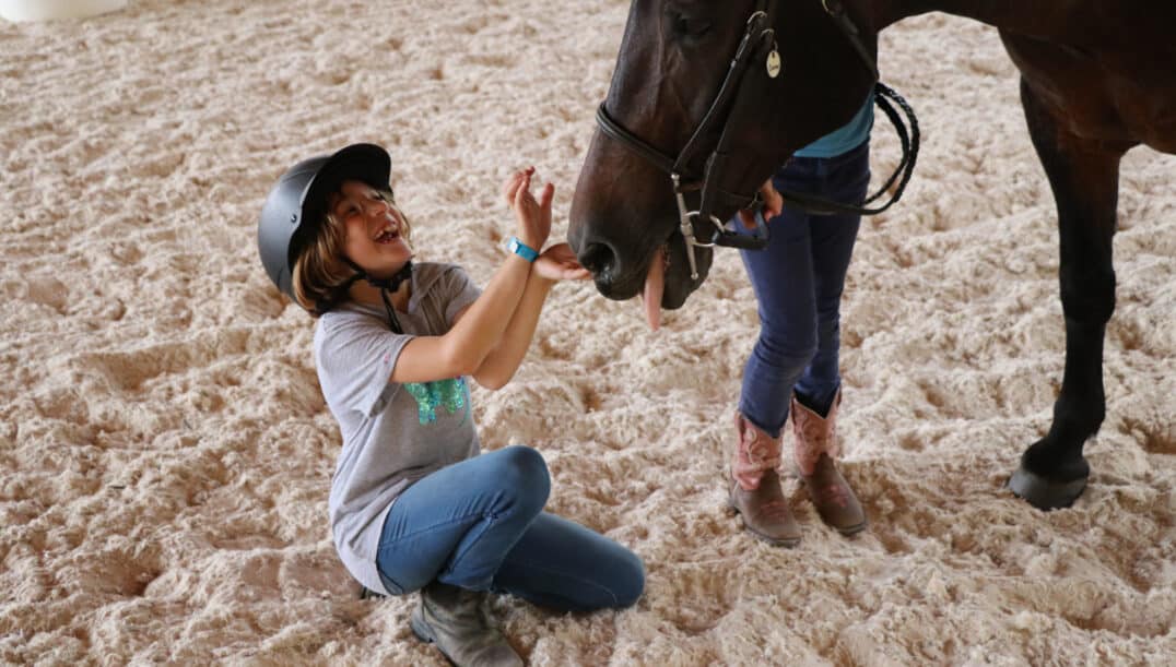 girl laughing with horse