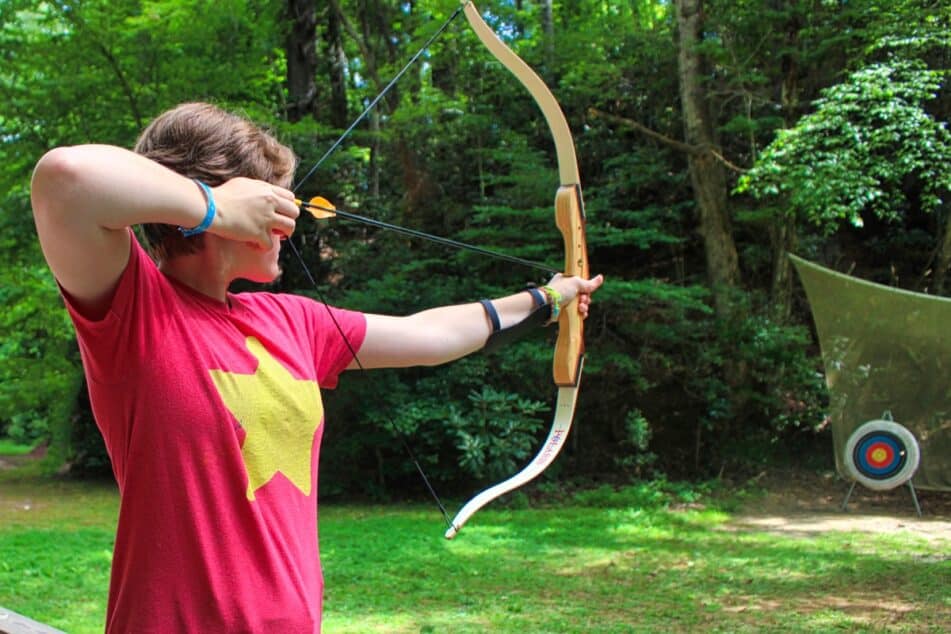 girl archery aiming at target