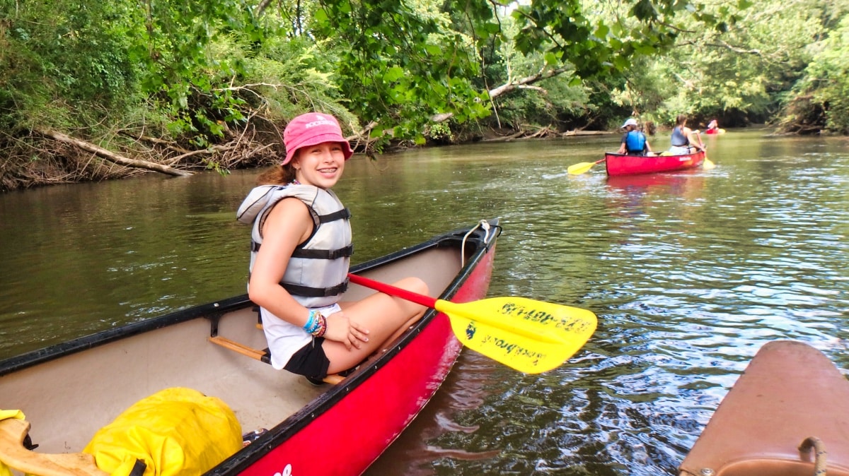 kid in canoe on camping trip