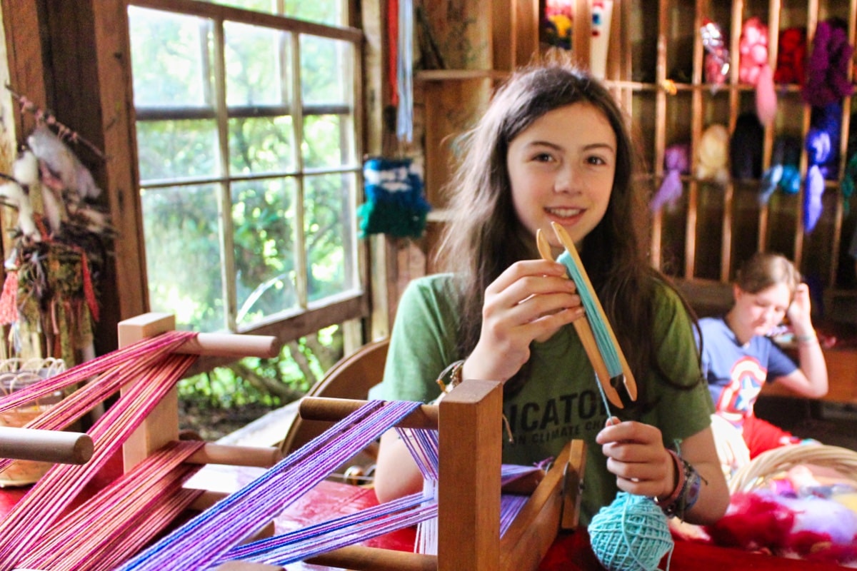 girls wrapping yarn for weaving