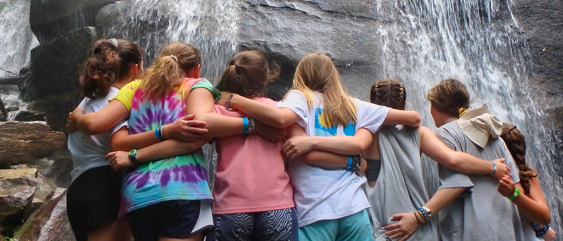 teenager girls in front of waterfall