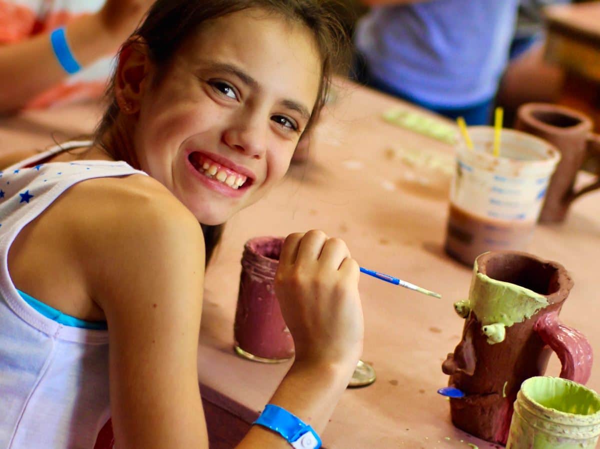 girls making ceramics crafts at camp