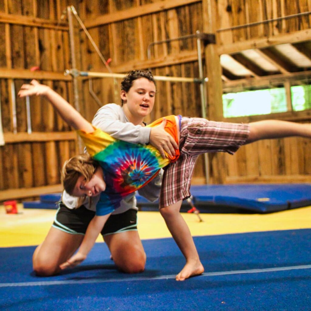 camp staff coaching gymnastics