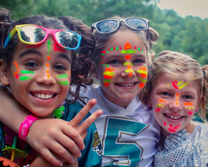 teen camp buddies with face paint