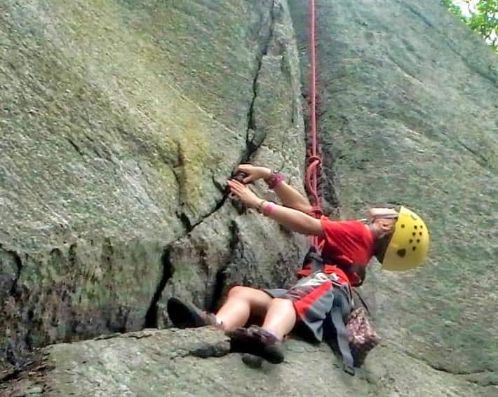 camp girl rock climbing outdoors