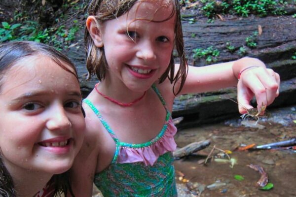 girl holding crawfish at summer camp