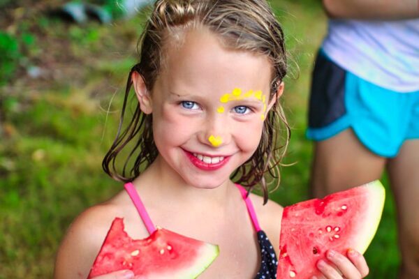 camp girl eating watermelon