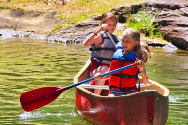 camp girls canoeing on lake