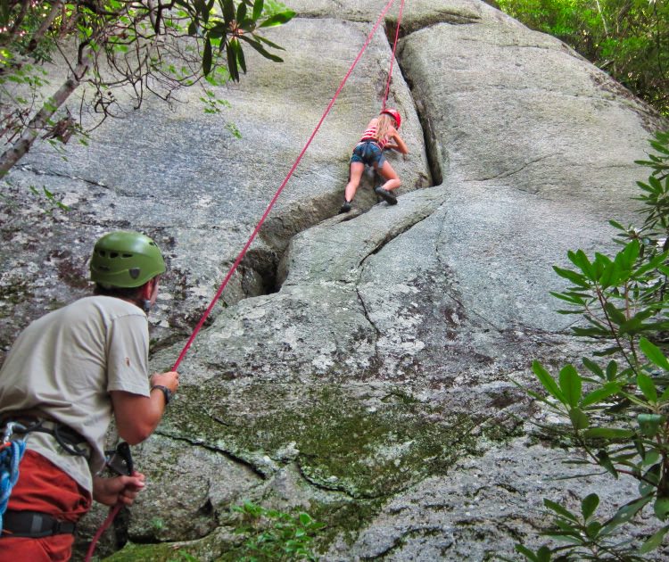 girl rock climbing at summer camp