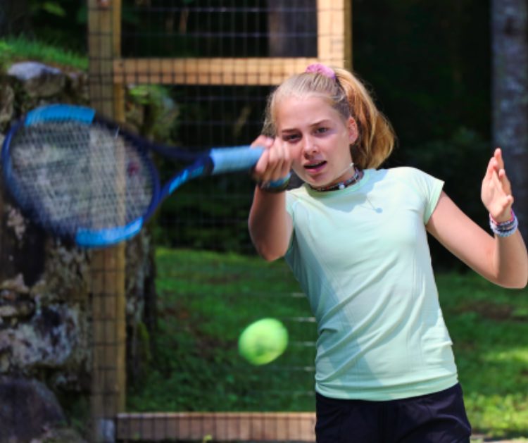 learning tennis at summer camp