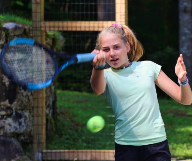 learning tennis at summer camp