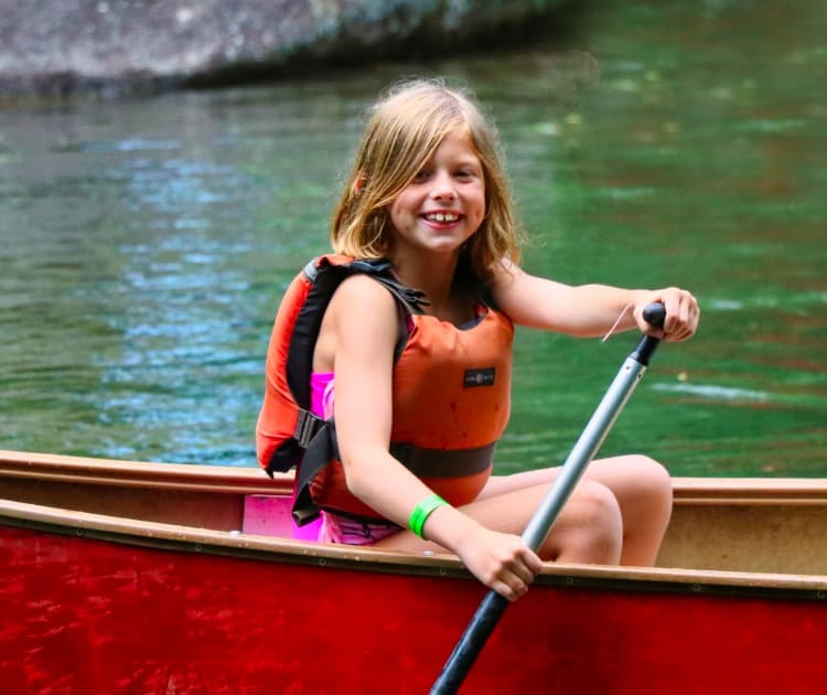 camp girl canoeing on lake