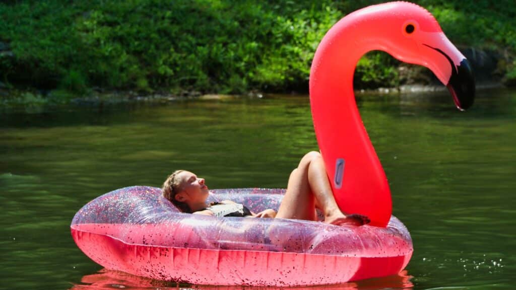 relaxing girl floating on camp lake