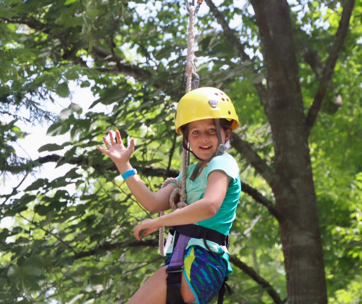 zip camp girl waving