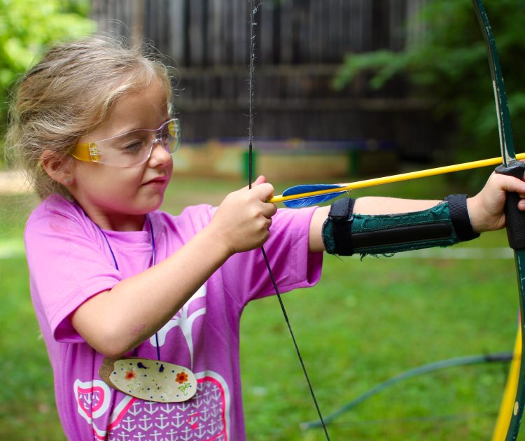 small girl shooting archery