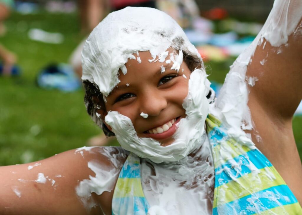 overnight camp girl covered in shaving cream