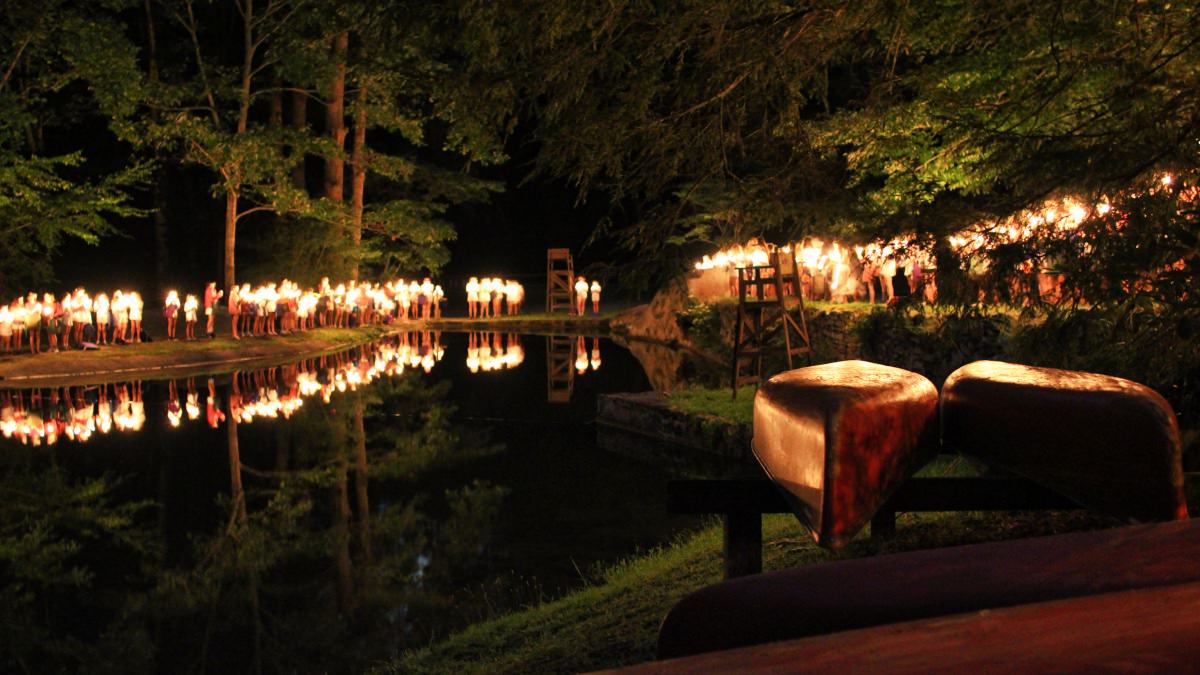 camp candle ceremony around lake