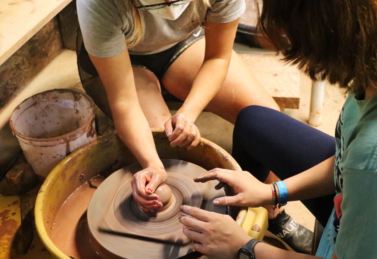 camp girl learning potters wheel