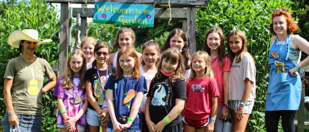 group of young campers at the garden with their teachers