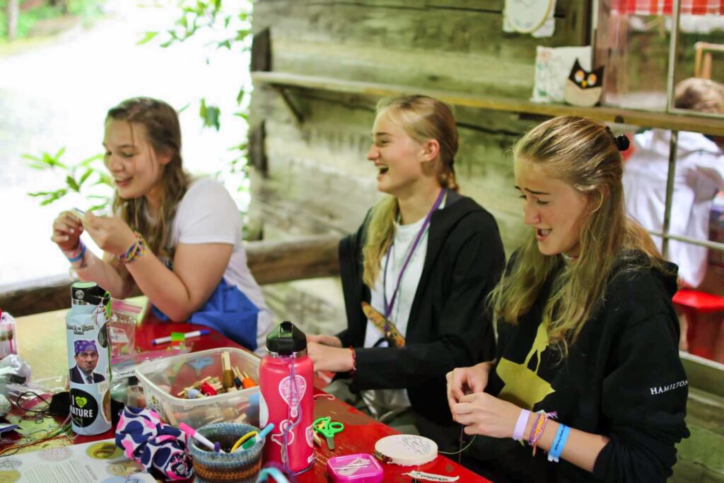 teenage girls doing needlecraft