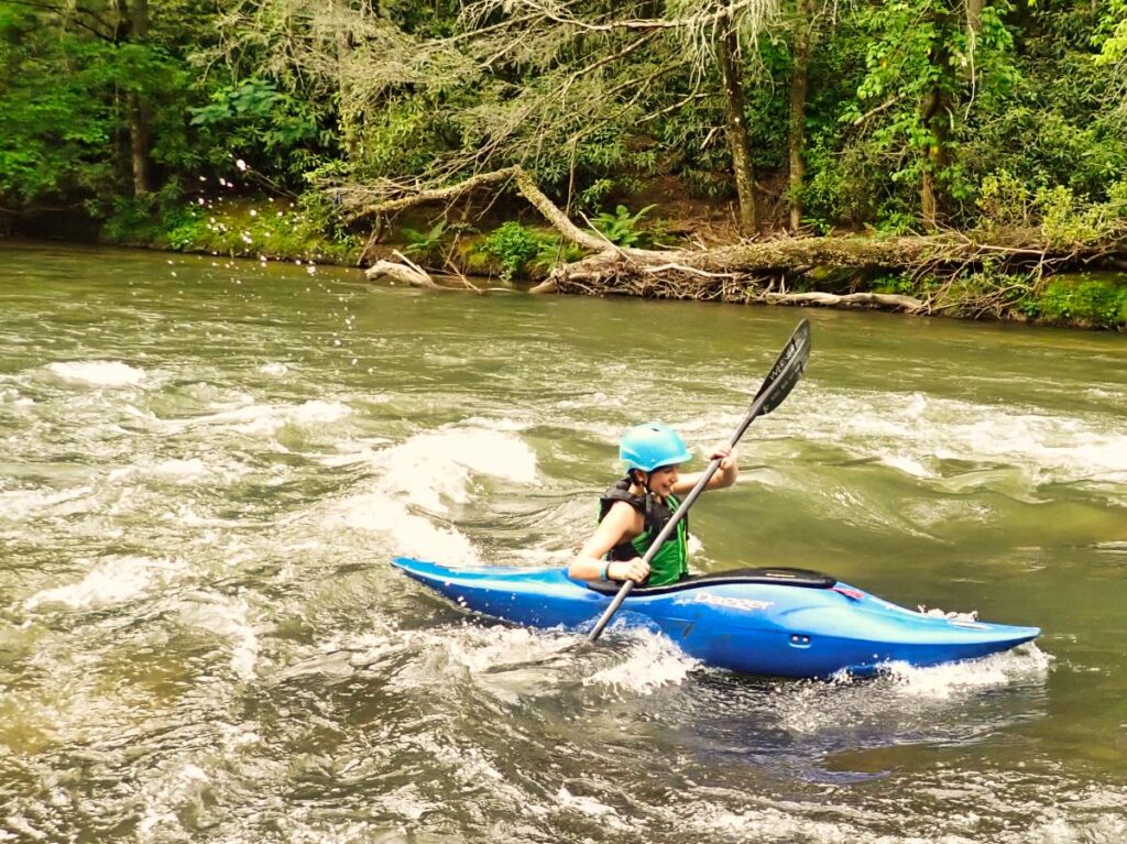 small kid whitewater kayaking