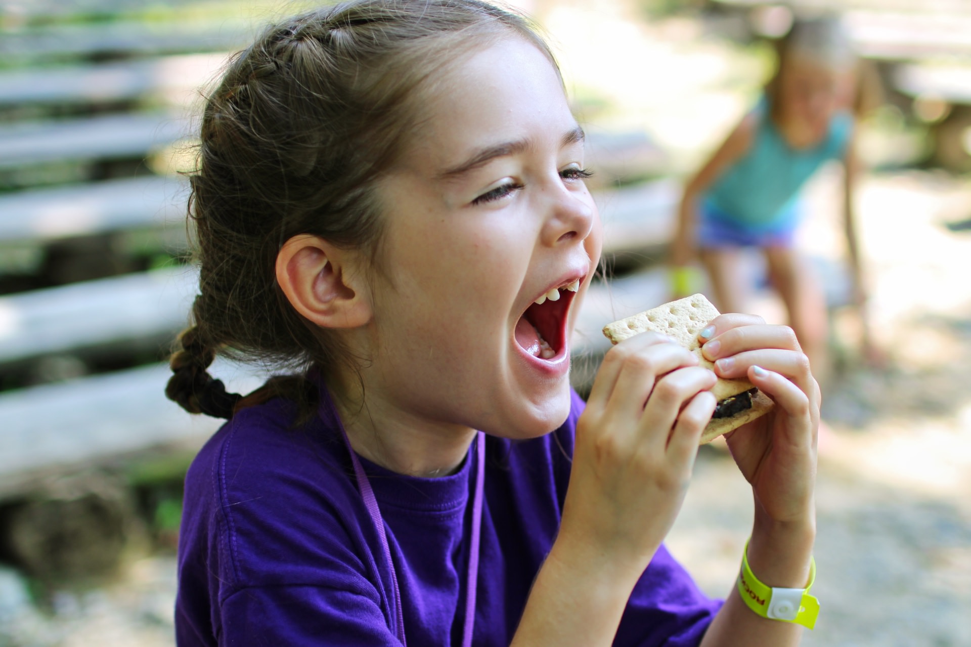 small child eating s'more