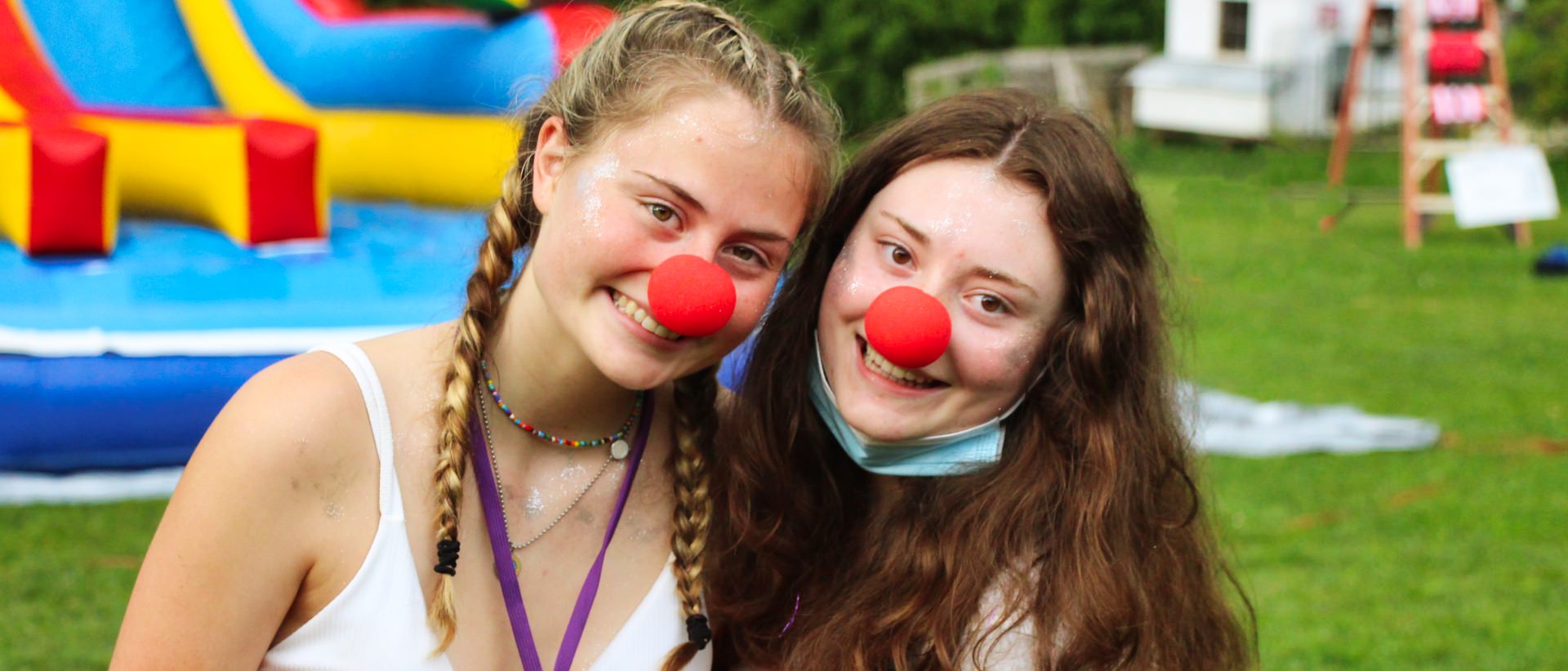 two teen girls wearing clown noses