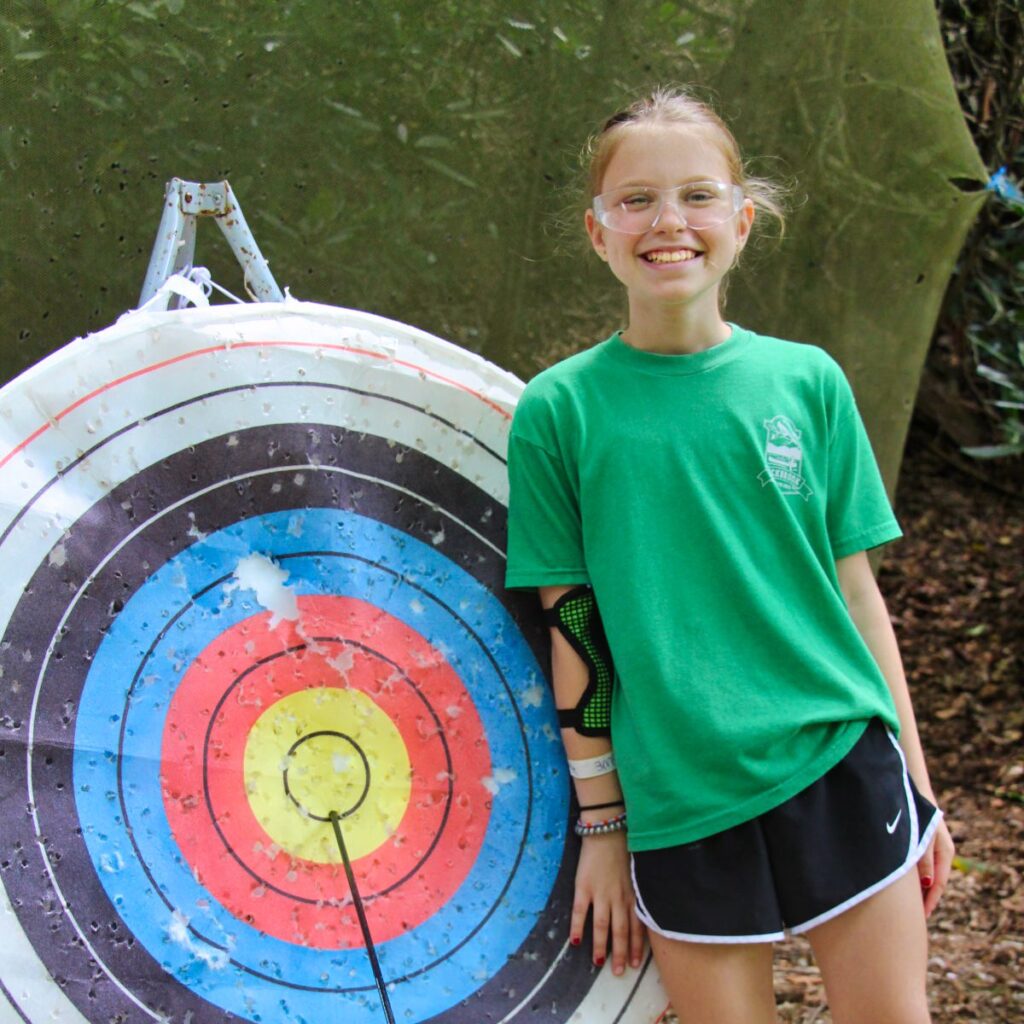 proud camp girl with archery bullseye