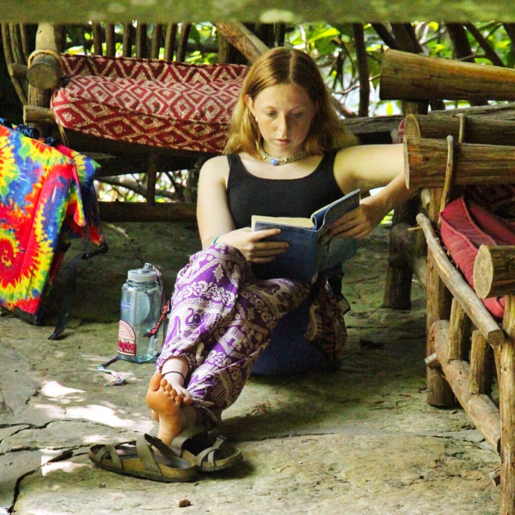 camp girl reading outdoors