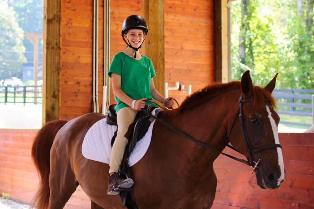 camp kid riding a horse