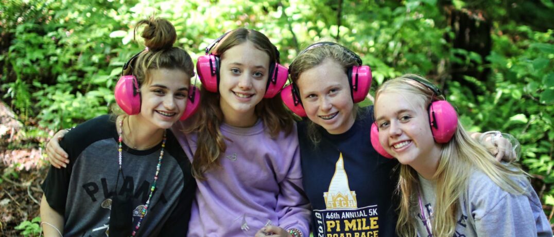 teen riflery girls wearing pink ear muffs